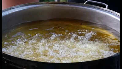 Woman accused of pouring hot oil on husband