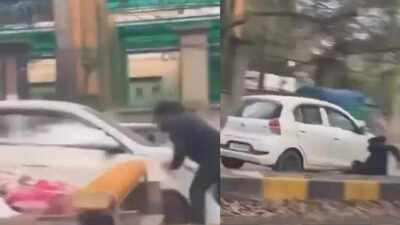 In the footage, the constable is seen clinging to the bonnet for some distance before falling on the road, after which he is hit by the vehicle. Watch: Delhi traffic cop dragged on bonnet after driver tries to flee drunk driving checkpoint