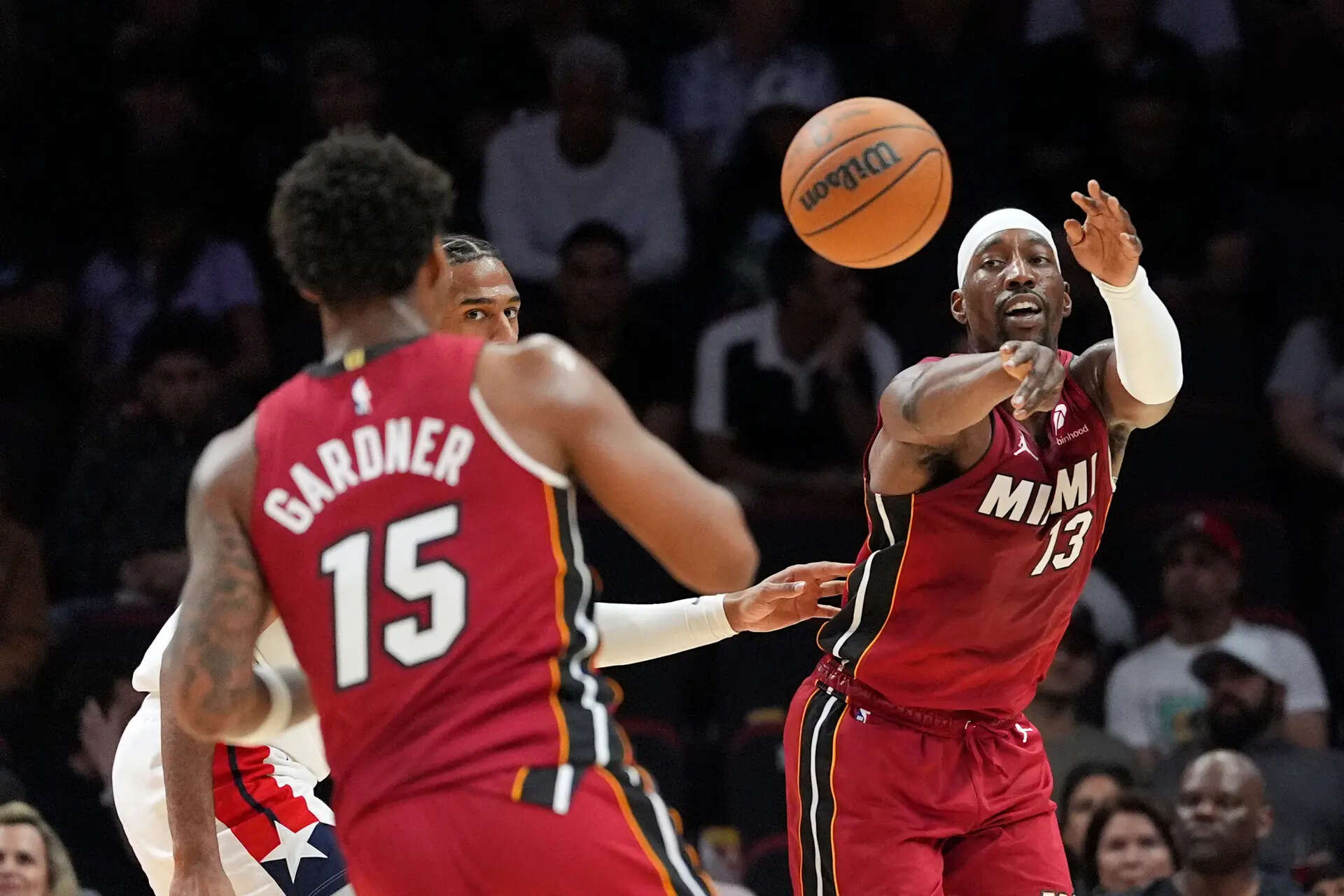 Miami Heat center Bam Adebayo (13) passes to forward Myron Gardner (15) as Washington Wizards center Alex Sarr looks on during the first half of an NBA basketball game, Tuesday, March 10, 2026, in Miami. (AP Photo/Rebecca Blackwell) Bam Adebayo scores 83 points, 2nd-best in NBA history, sets FT records in Heat win over Wizards