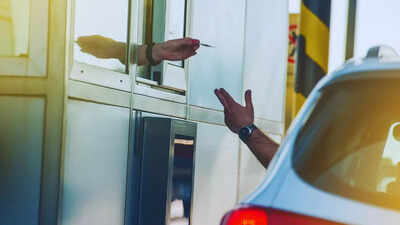 Traveller at a toll booth FASTag annual pass fee revised; new rate to take effect from April 1 – here’s what travellers need to know